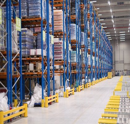 Warehouse storage interior with shelves loaded with goods.